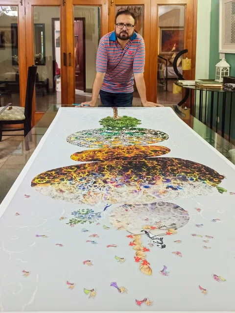 A long print of Muhammad Atif Khan’s work laid flat on a table
